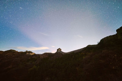 Low angle view of mountain against sky at night