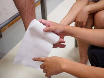 Midsection of couple holding hands