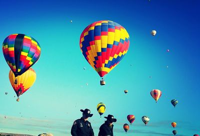Hot air balloons flying over blue sky