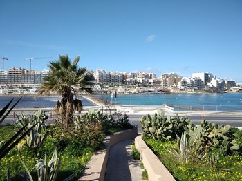 Scenic view of swimming pool by buildings against sky