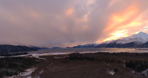 Scenic view of snowcapped mountains against sky during sunset