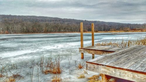 Scenic view of lake against sky during winter