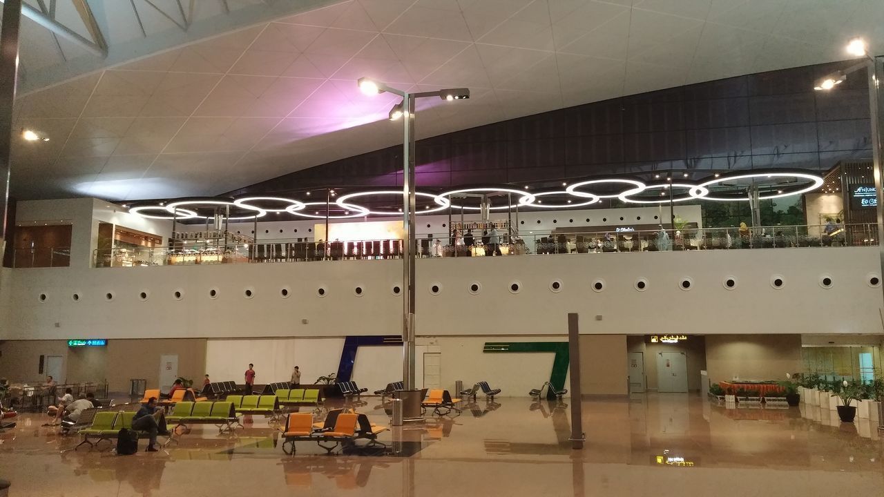 ILLUMINATED LIGHTS IN BUILDING SEEN THROUGH GLASS