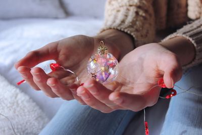 Close-up of woman holding red hand