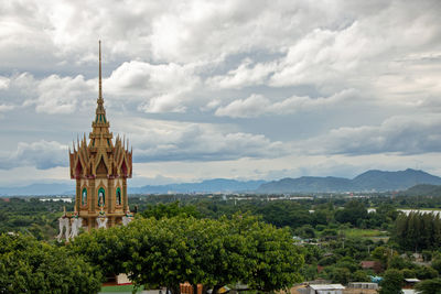 Temple by building against sky