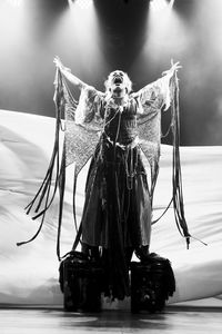 Actress representing a character on the stage of a theater. 