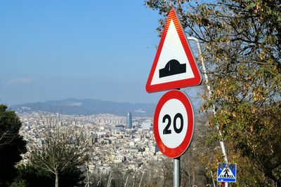 Road sign against sky