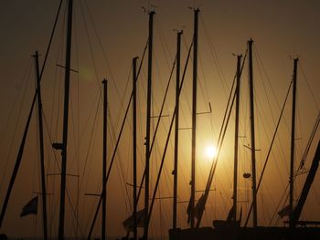 Silhouette sailboats on sea against sky during sunset