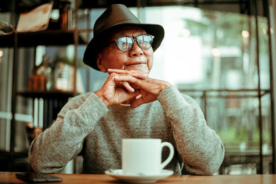 Portrait of man with coffee cup in cafe