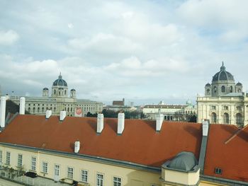 Buildings against cloudy sky