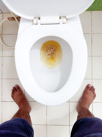 Person standing pee down in the toilet