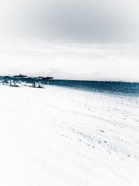 Scenic view of beach against sky during winter