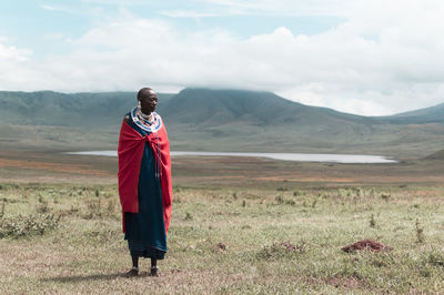 Full length of man standing on field against sky