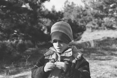 Boy wearing warm clothing on field