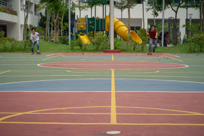 Children roller skating in playground