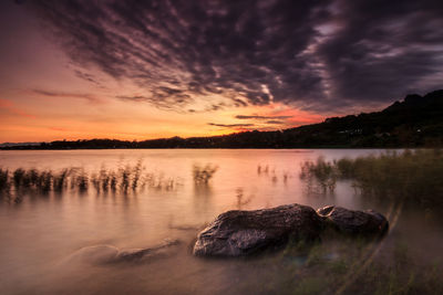 Scenic view of lake against sky during sunset