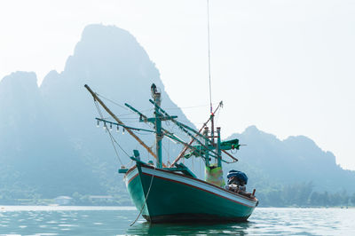 Boat sailing in sea against sky