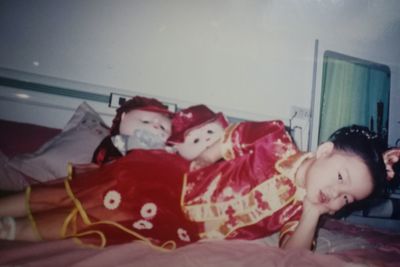 Portrait of cute girl relaxing on bed at home