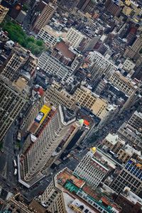 High angle view of flatiron building amidst towers in city
