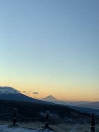 Scenic view of mountains against clear sky during sunset
