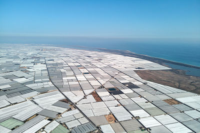 High angle view of sea against clear blue sky