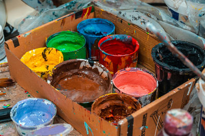 Jars with bright colors in an art workshop