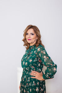 Portrait of woman standing against white background