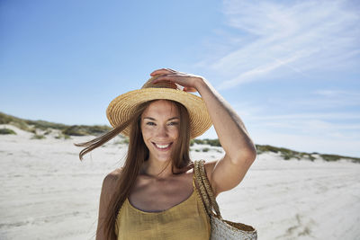 Portrait of smiling young woman on the beach