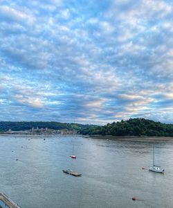 Sailboats sailing in sea against sky