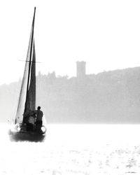 Man in boat against sky