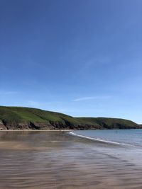 Scenic view of sea against blue sky