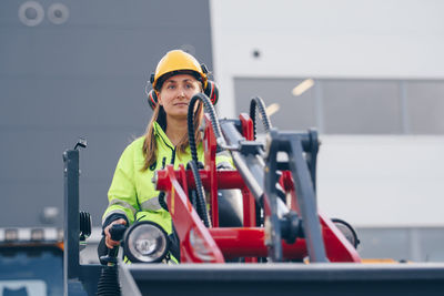 Woman with machinery at construction site