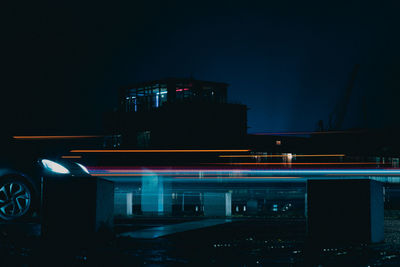 Illuminated light trails on street in city at night