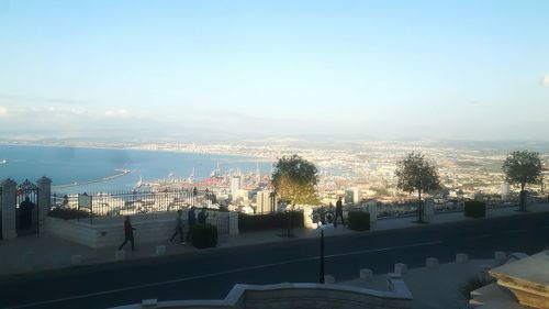 Cityscape by sea against sky