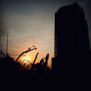 Silhouette people against the sky at sunset