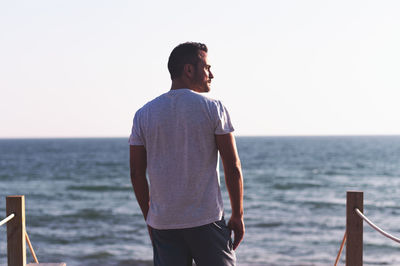 Man standing on beach against sky