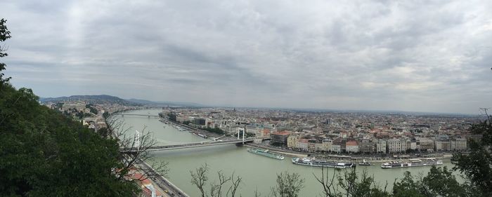River in city against cloudy sky