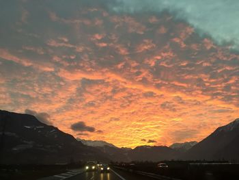 Scenic view of mountains against orange sky