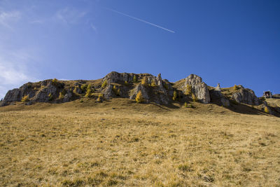 Low angle view of rocks against sky