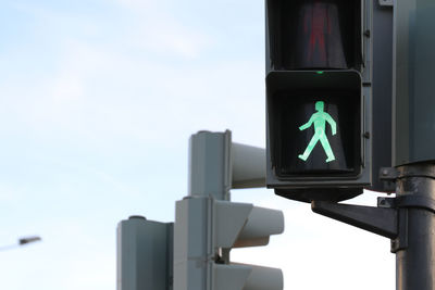 Close-up of traffic signal against the sky