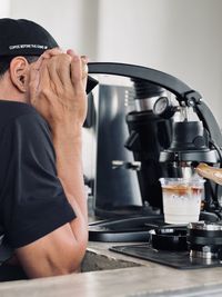 Midsection of man working in kitchen