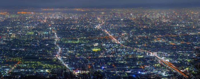 High angle view of city lit up at night