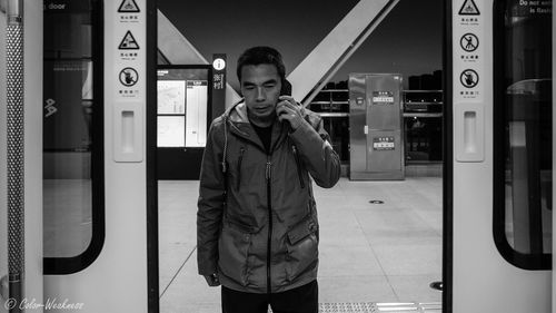 Full length of boy standing by train