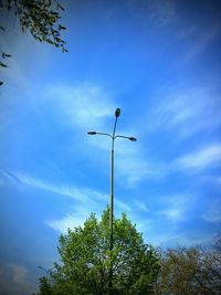 Low angle view of street light against cloudy sky