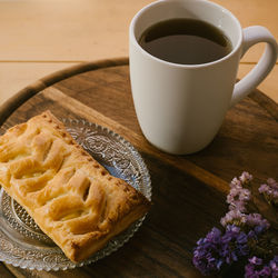 Close-up of coffee and puff pastry on table