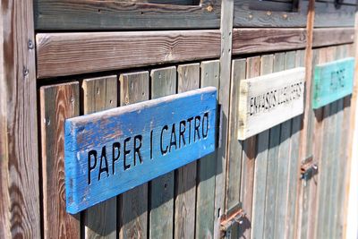 Close-up of text on wooden fence