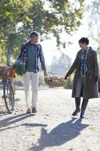 Mature couple with basket full of apples, stockholm, sweden