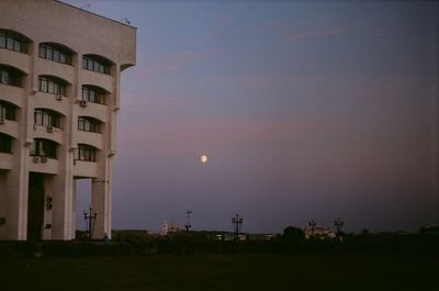 Buildings against clear sky at sunset