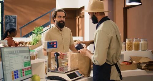 Side view of man working in cafe