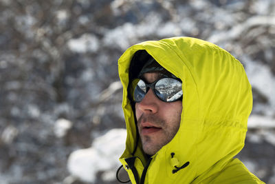 Close-up of man wearing sunglasses while looking away